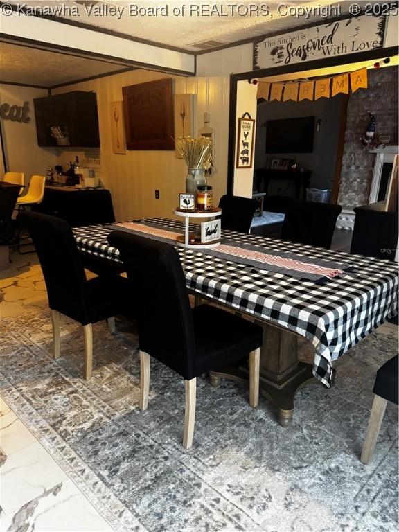969 Airport Rd, Chapmanville, WV 25508 - dining space with marble finish floors and a textured ceiling