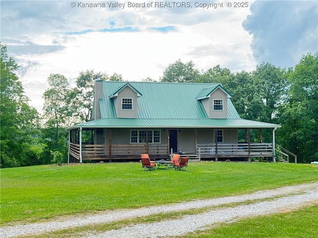 4136 Iva Durst Rd, Leon, WV 25123 - farmhouse-style home featuring covered porch, a front lawn, a metal roof, driveway, and view of wooded area