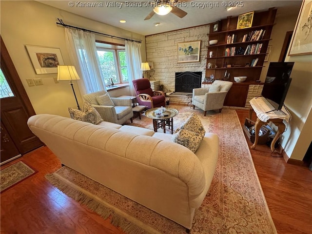 201 Sheridan Cir, Charleston, WV 24315 - living area with wood finished floors, ceiling fan, and a stone fireplace