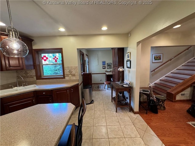 201 Sheridan Cir, Charleston, WV 24315 - kitchen with light countertops, recessed lighting, tasteful backsplash, light tile patterned floors, and dark brown cabinetry