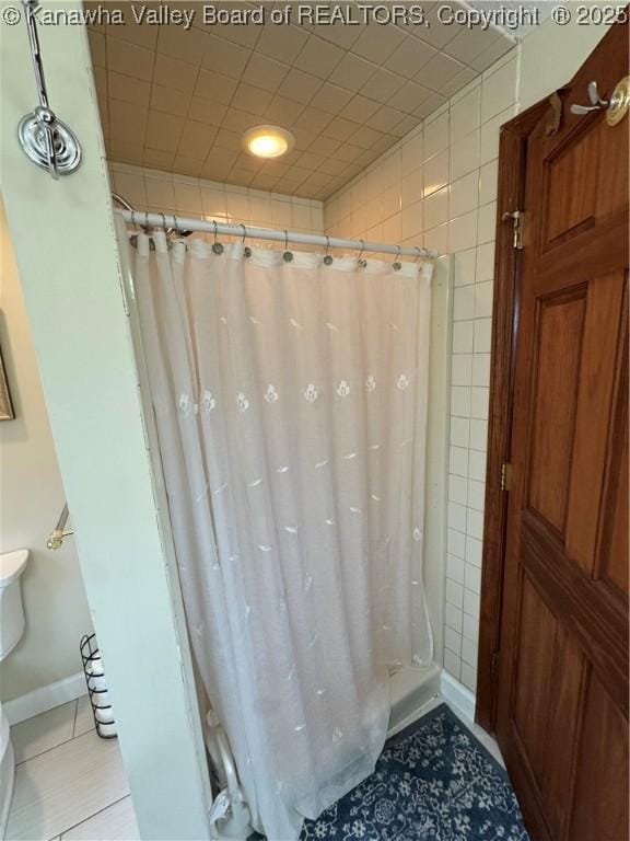 201 Sheridan Cir, Charleston, WV 24315 - bathroom with tile patterned floors, a shower with shower curtain, and tile walls