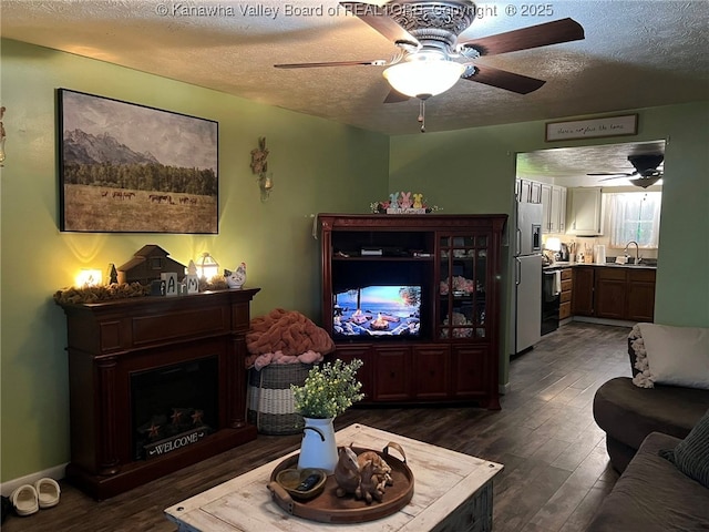 1324 13th St, Nitro, WV 25143 - living area with ceiling fan, a textured ceiling, dark wood-type flooring, and a fireplace