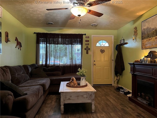 1324 13th St, Nitro, WV 25143 - living room with dark wood-type flooring, a textured ceiling, ceiling fan, and a fireplace