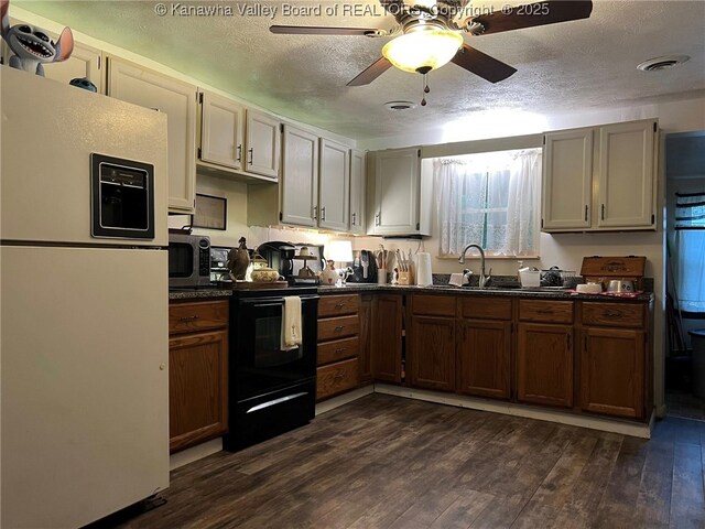 1324 13th St, Nitro, WV 25143 - kitchen featuring freestanding refrigerator, black / electric stove, dark countertops, stainless steel microwave, and a textured ceiling