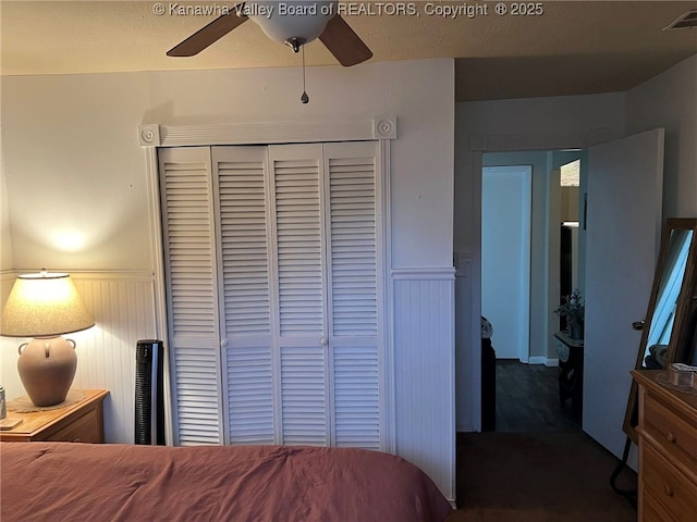 1324 13th St, Nitro, WV 25143 - carpeted bedroom with wainscoting, a closet, and ceiling fan