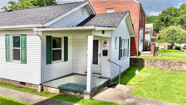 108 W Main St, Belle, WV 25015 - view of front of property featuring roof with shingles, a front lawn, and crawl space