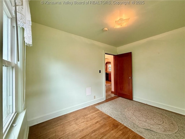 108 W Main St, Belle, WV 25015 - spare room with arched walkways, wood finished floors, and a smoke detector