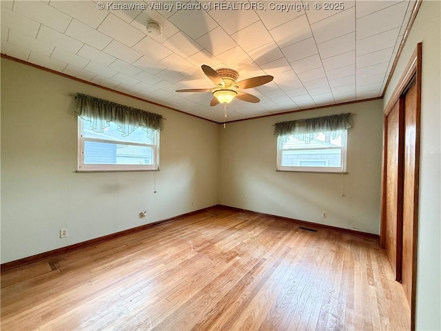 108 W Main St, Belle, WV 25015 - spare room with healthy amount of natural light, ornamental molding, a smoke detector, light wood-style flooring, and a ceiling fan