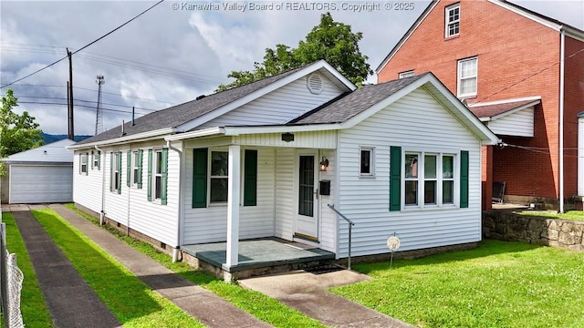 108 W Main St, Belle, WV 25015 - view of front of property with a garage, a front lawn, an outbuilding, covered porch, and a shingled roof
