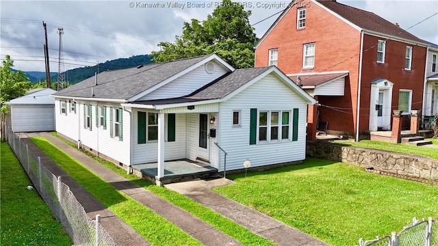108 W Main St, Belle, WV 25015 - view of front of house featuring a detached garage, roof with shingles, a porch, and an outbuilding