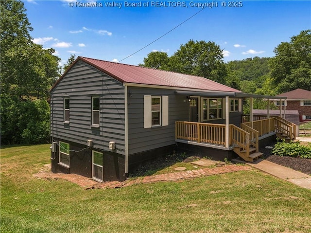 5285 Kelly Rd, Charleston, WV 25313 - back of property featuring a lawn, covered porch, and a metal roof