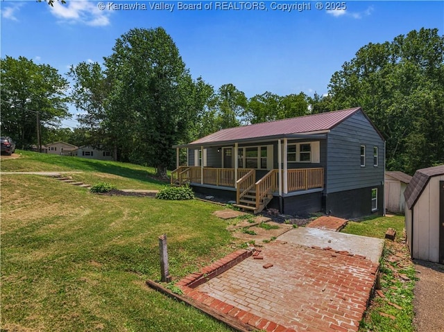 5285 Kelly Rd, Charleston, WV 25313 - view of front facade with covered porch, a front yard, a shed, and a metal roof