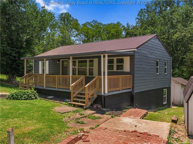 5285 Kelly Rd, Charleston, WV 25313 - view of front of house with covered porch, a front yard, and a metal roof