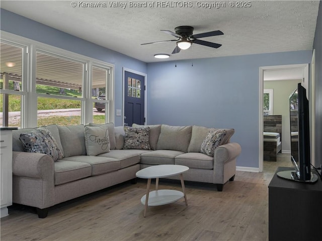 5285 Kelly Rd, Charleston, WV 25313 - living area featuring light wood finished floors, a ceiling fan, and a textured ceiling