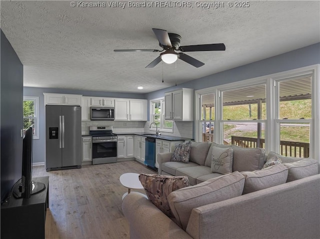 5285 Kelly Rd, Charleston, WV 25313 - living room with ceiling fan, light wood-type flooring, and a textured ceiling