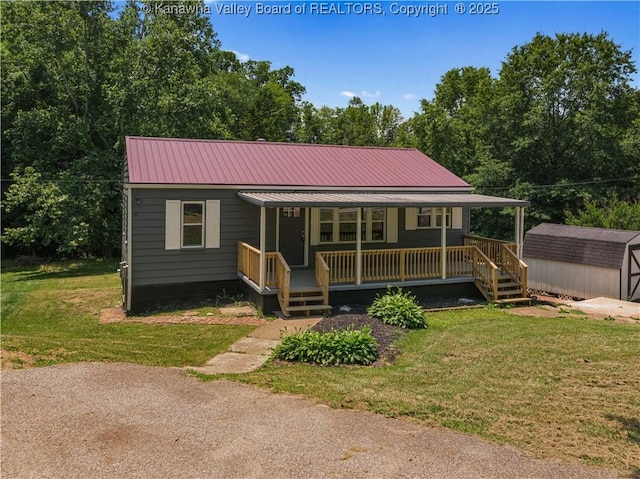 5285 Kelly Rd, Charleston, WV 25313 - view of front of house with covered porch, a storage unit, a front yard, and a metal roof