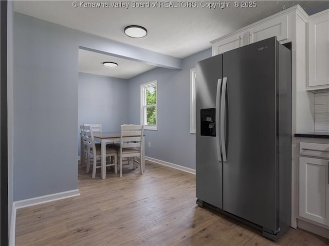 5285 Kelly Rd, Charleston, WV 25313 - kitchen featuring stainless steel fridge, wood finished floors, white cabinetry, and dark countertops