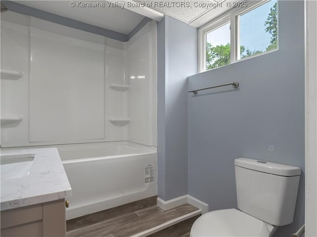 5285 Kelly Rd, Charleston, WV 25313 - bathroom featuring wood finished floors, vanity, and washtub / shower combination