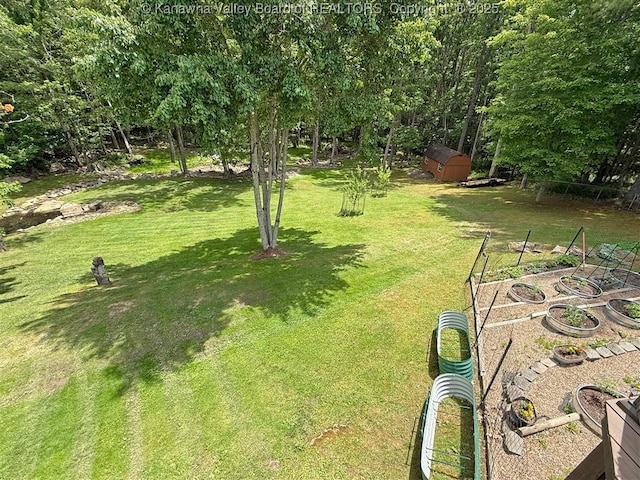 960 Grandview Rd, Daniels, WV 25832 - view of grassy yard featuring a garden and a storage shed
