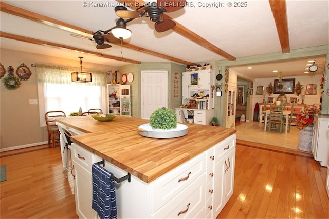 960 Grandview Rd, Daniels, WV 25832 - kitchen with wooden counters, a ceiling fan, beam ceiling, light wood-type flooring, and white cabinets