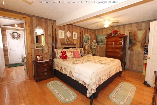 960 Grandview Rd, Daniels, WV 25832 - bedroom featuring wooden walls, light wood-style flooring, beamed ceiling, a textured ceiling, and a ceiling fan