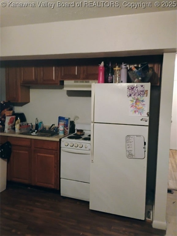 322 16th St, Dunbar, WV 25064 - kitchen with white appliances, under cabinet range hood, dark wood-style flooring, and light countertops
