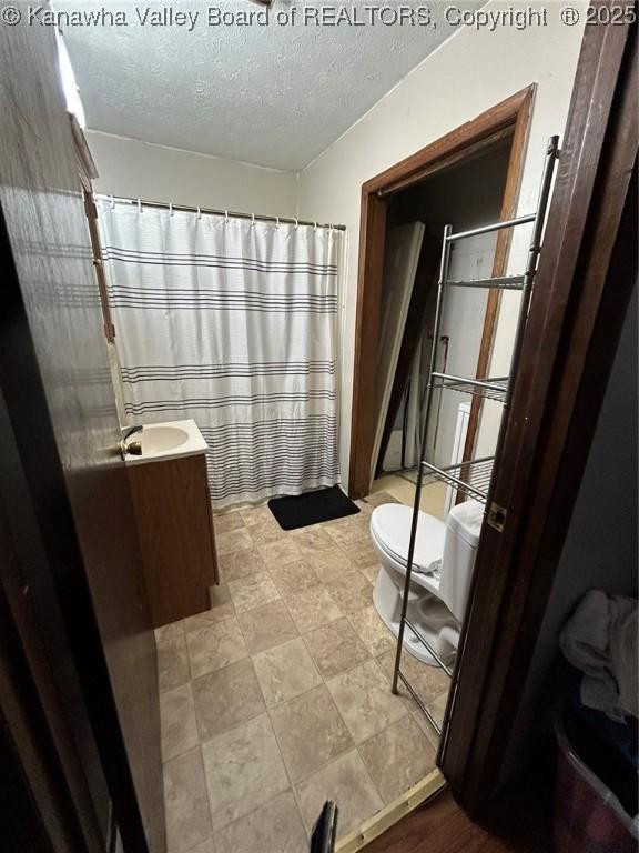 322 16th St, Dunbar, WV 25064 - bathroom featuring vanity and a textured ceiling