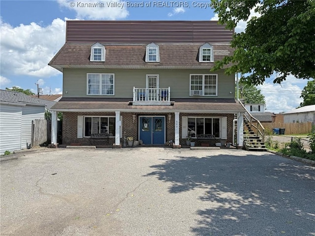 322 16th St, Dunbar, WV 25064 - view of front facade featuring brick siding, a porch, a shingled roof, and stairs