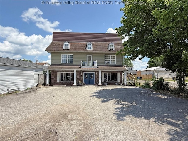 322 16th St, Dunbar, WV 25064 - view of front of home with stairway, covered porch, and brick siding
