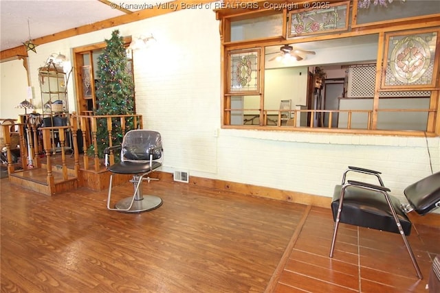 322 16th St, Dunbar, WV 25064 - living area with wood finished floors and brick wall