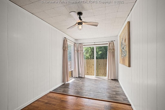9627 Procious Maysel Rd, Procious, WV 25164 - unfurnished room featuring dark wood finished floors, ceiling fan, and wooden walls