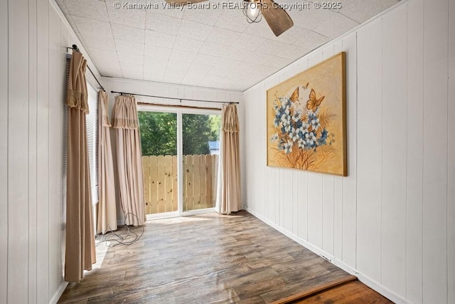 9627 Procious Maysel Rd, Procious, WV 25164 - spare room with wood finished floors, wooden walls, and a ceiling fan