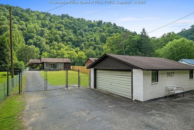9627 Procious Maysel Rd, Procious, WV 25164 - detached garage with a gate and a view of trees