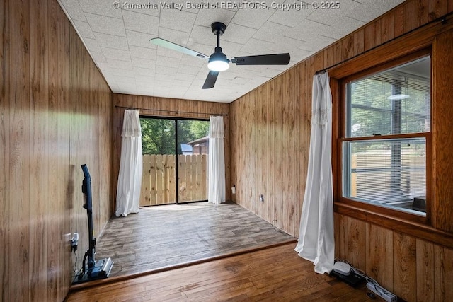 9627 Procious Maysel Rd, Procious, WV 25164 - unfurnished room featuring wood walls, a ceiling fan, and wood finished floors