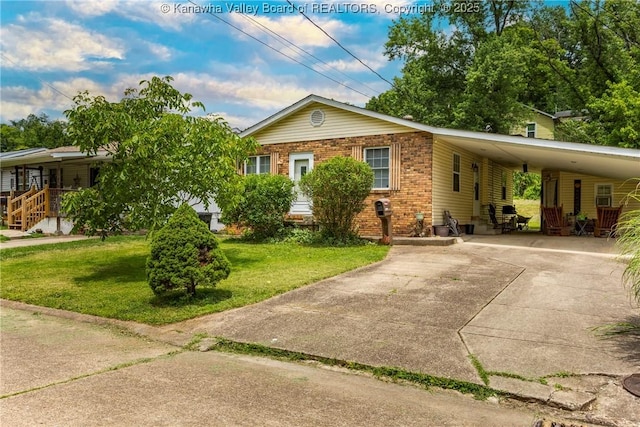 3983 39th St E, Nitro, WV 25143 - view of front of house featuring driveway, a carport, a front yard, and brick siding