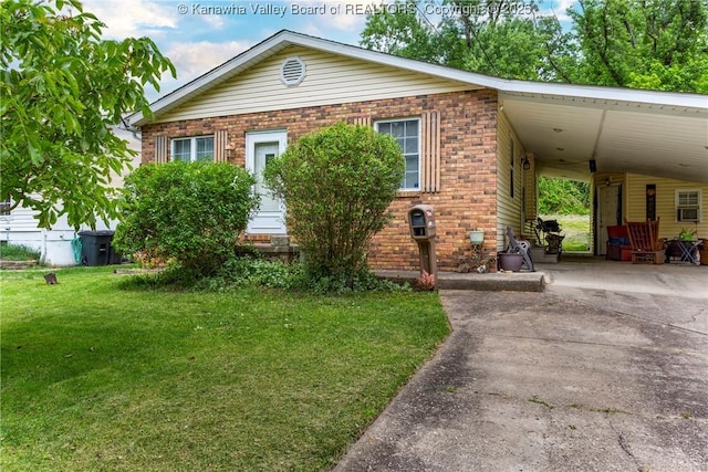 3983 39th St E, Nitro, WV 25143 - view of front facade with brick siding, concrete driveway, an attached carport, and a front yard