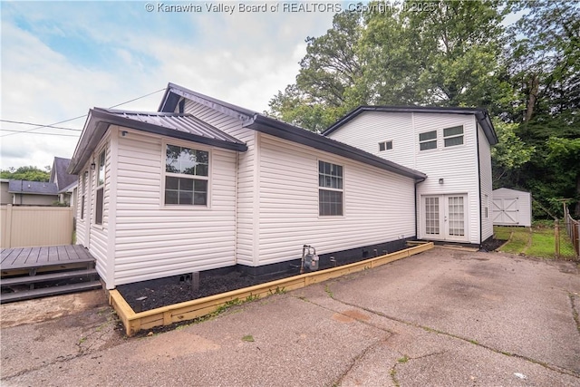 2023 Roxalana Rd, Dunbar, WV 25064 - view of side of home with french doors, a wooden deck, a metal roof, and crawl space