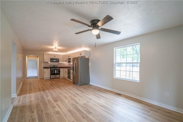 2023 Roxalana Rd, Dunbar, WV 25064 - unfurnished living room featuring light wood-type flooring and ceiling fan