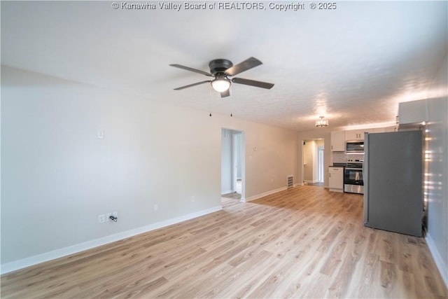 2023 Roxalana Rd, Dunbar, WV 25064 - unfurnished living room featuring ceiling fan and light wood-style floors
