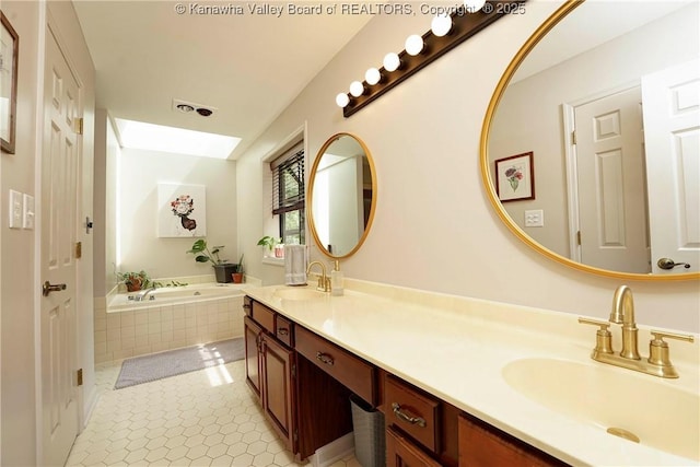 32 Carriage Rd, Charleston, WV 25314 - bathroom featuring a skylight, double vanity, a garden tub, and tile patterned floors