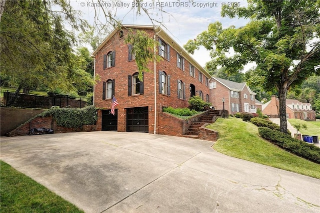 32 Carriage Rd, Charleston, WV 25314 - view of property with an attached garage, driveway, and stairs