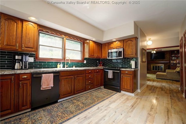 32 Carriage Rd, Charleston, WV 25314 - kitchen with dishwasher, stainless steel microwave, black range with electric stovetop, ceiling fan, and brown cabinets