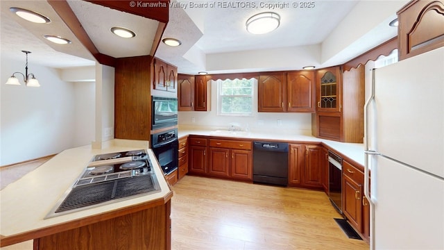 81 Hamill Rd, Huntington, WV 25701 - kitchen featuring black appliances, light countertops, a peninsula, brown cabinetry, and recessed lighting