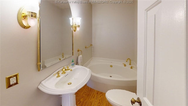 81 Hamill Rd, Huntington, WV 25701 - bathroom featuring a garden tub and wood finished floors