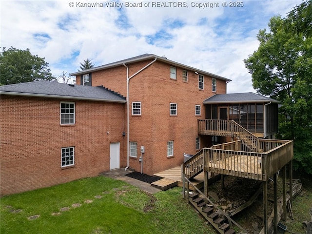 81 Hamill Rd, Huntington, WV 25701 - rear view of property with a sunroom, stairway, a wooden deck, a lawn, and brick siding
