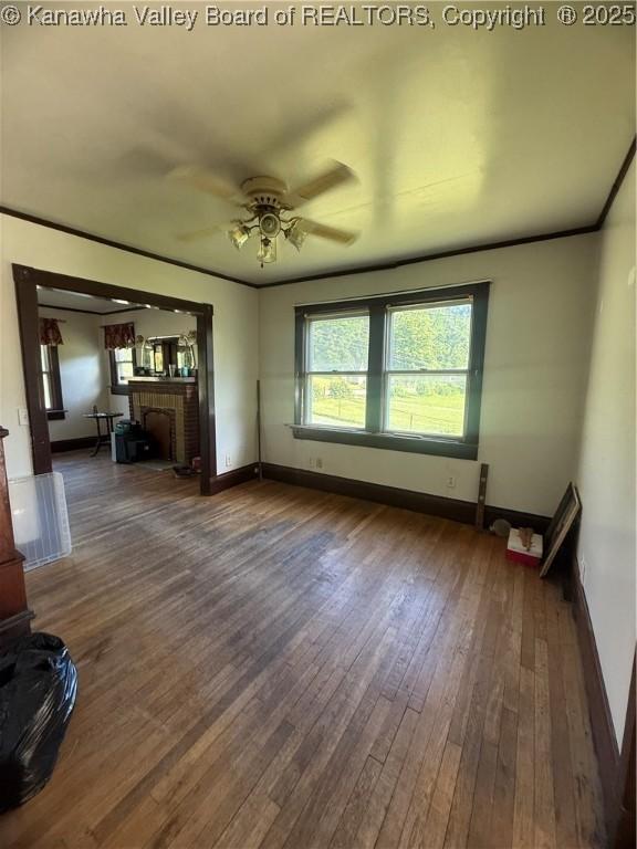 23908 Coal River Rd, Wv, WV 25148 - unfurnished living room with hardwood / wood-style floors, a ceiling fan, and a brick fireplace