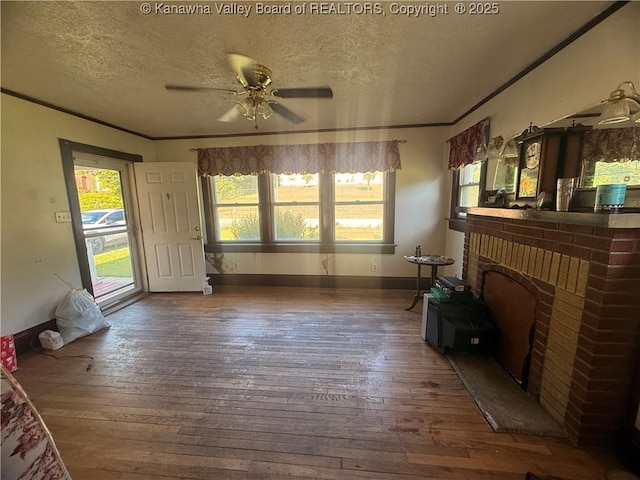 23908 Coal River Rd, Wv, WV 25148 - unfurnished living room with a textured ceiling, hardwood / wood-style floors, a ceiling fan, ornamental molding, and a fireplace