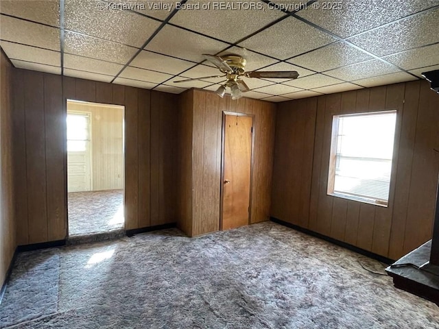 1325 Stuart St, Charleston, WV 25302 - empty room featuring carpet flooring, wooden walls, ceiling fan, and a paneled ceiling