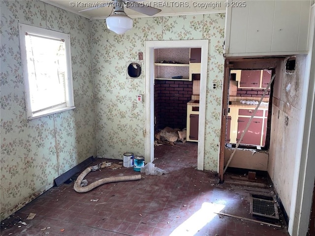 1325 Stuart St, Charleston, WV 25302 - empty room with brick patterned floors, ceiling fan, and wallpapered walls