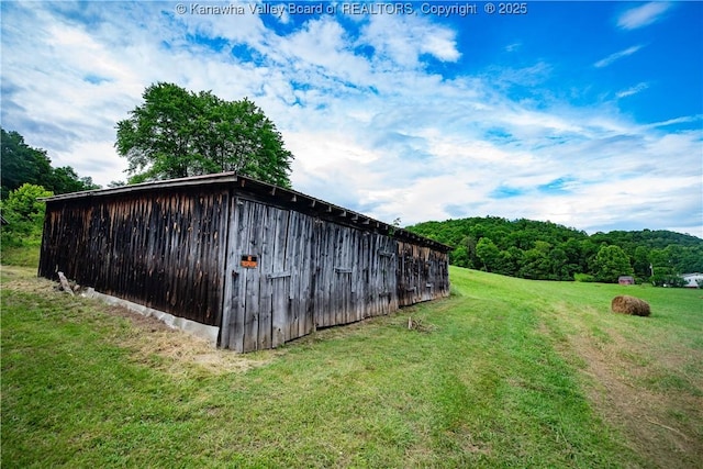 449 Lee Creek Rd, Culloden, WV 25510 - view of pole building featuring a yard and a wooded view